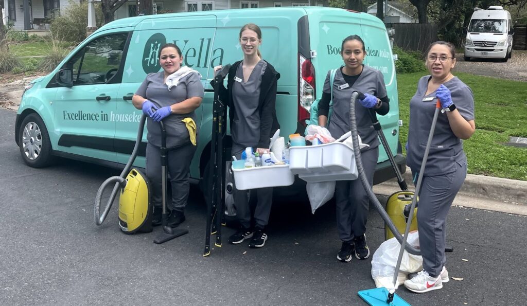 "Team of professional cleaners standing in front of a van with cleaning supplies, ready to help with cleaning your kitchen and home."