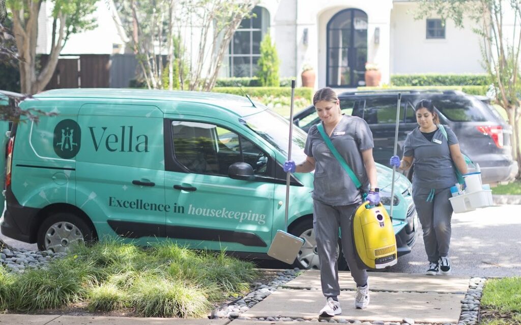 Two housekeeping professionals carrying cleaning tools and supplies, ready to deliver excellence in housekeeping services.






