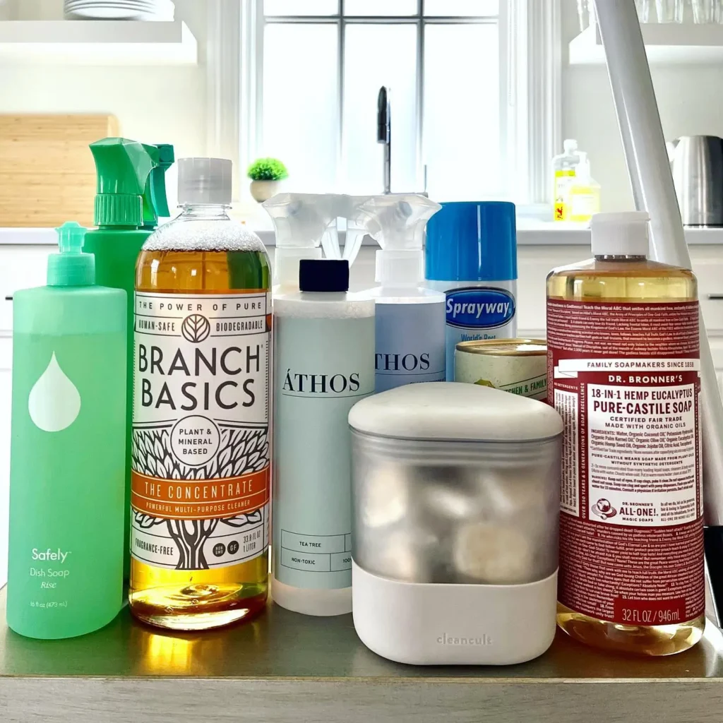 A collection of non-toxic, eco-friendly cleaning products, including Branch Basics and Dr. Bronner’s soap, used by Vella Clean.