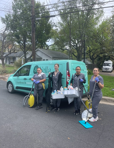 Vella’s cleaning staff standing in front of their company van