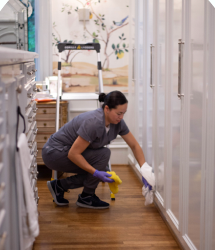 A Vella employee deep cleaning the house with eco-friendly cleaning products. 
