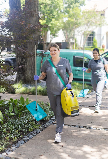 The Vella cleaning staff walks into a client’s home with vacuums and cleaning devices
