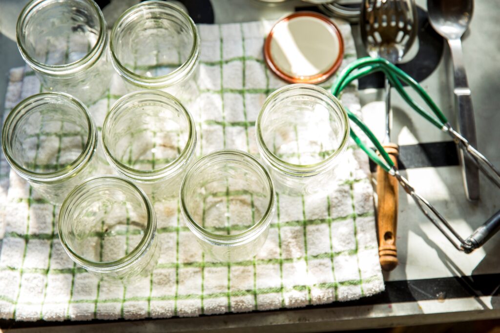 Seven mason jars kept on a cotton cloth after cleaning. 
