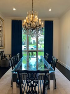 A Texas home interior with a long dining table and large glass window.
