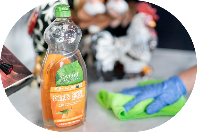Eco-friendly dish soap like Seventh Generation Natural Dish Liquid on a kitchen counter with a reusable cloth.
